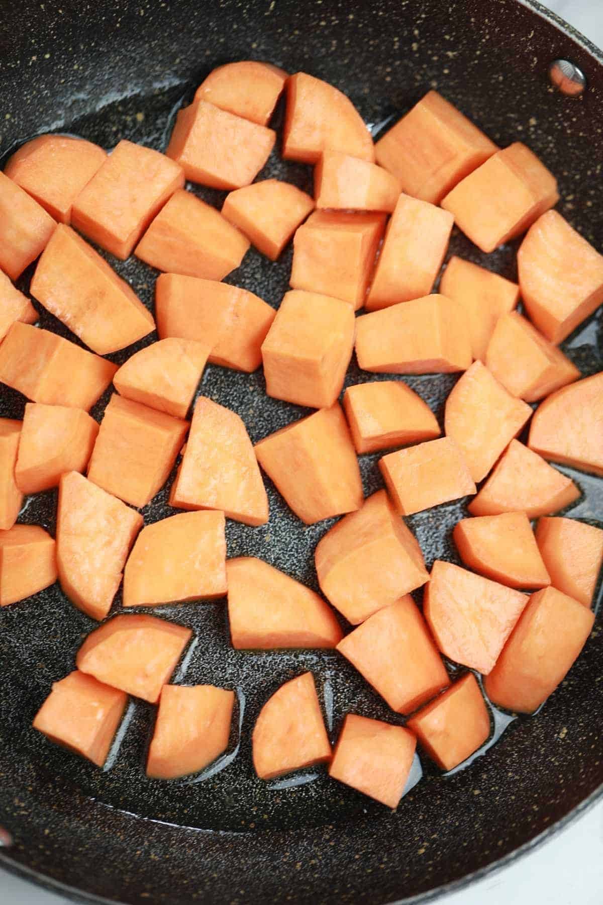 sweet potatoes in a frying pan.