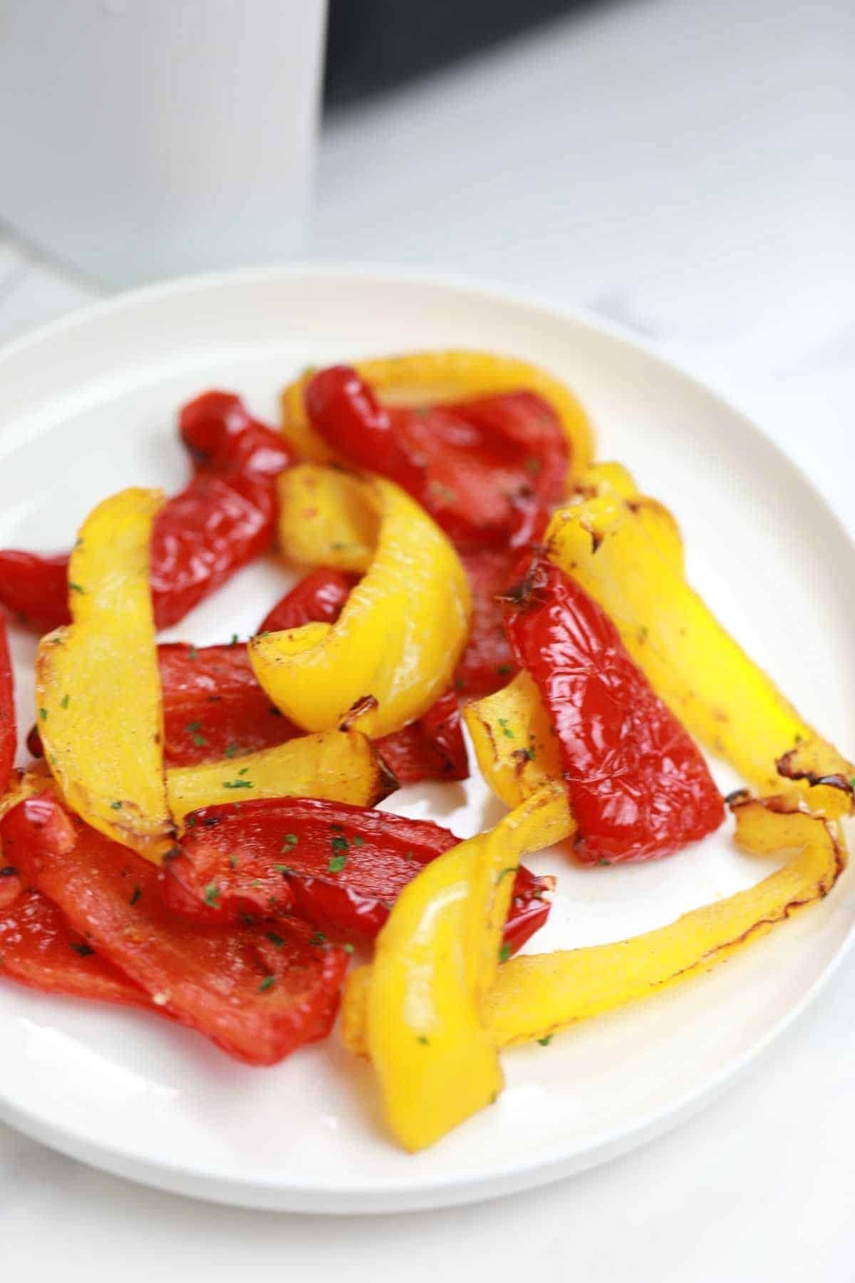 air fryer roasted peppers served on a white plate.