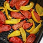 Air fryer bell peppers in air fryer basket.