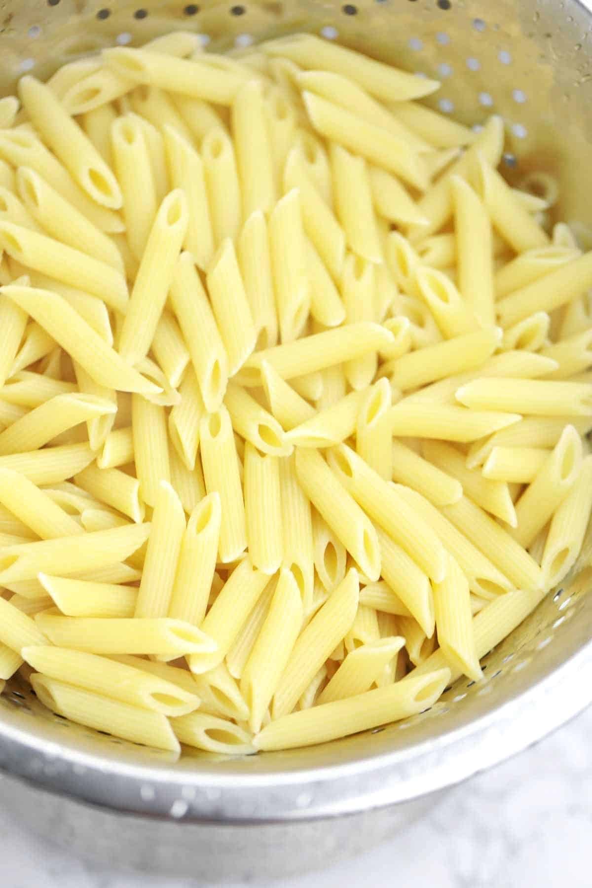 Boiled pasta in a colander.