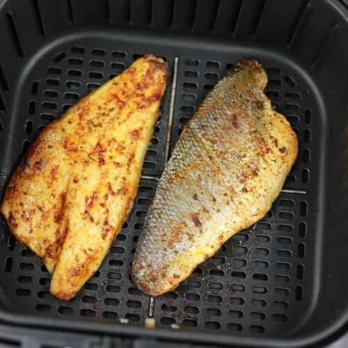 Air fryer sea bass fillets displayed in the air fryer.