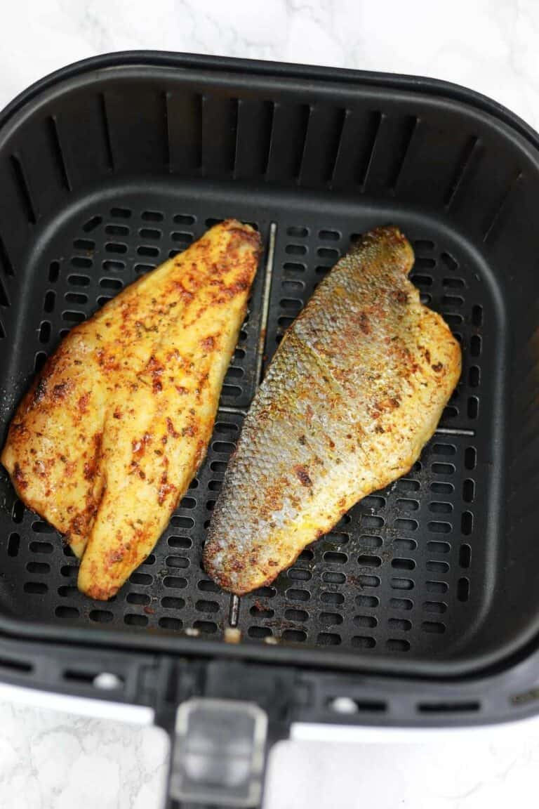 Air fryer sea bass fillets displayed in the air fryer.