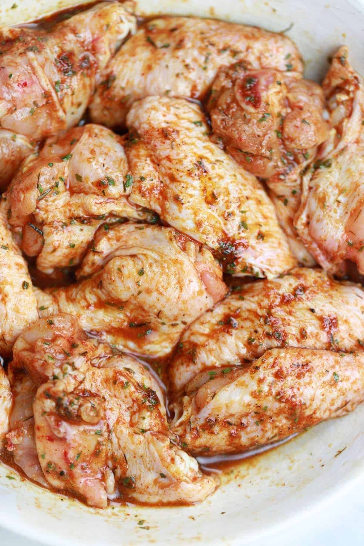 marinated chicken wings in a bowl.