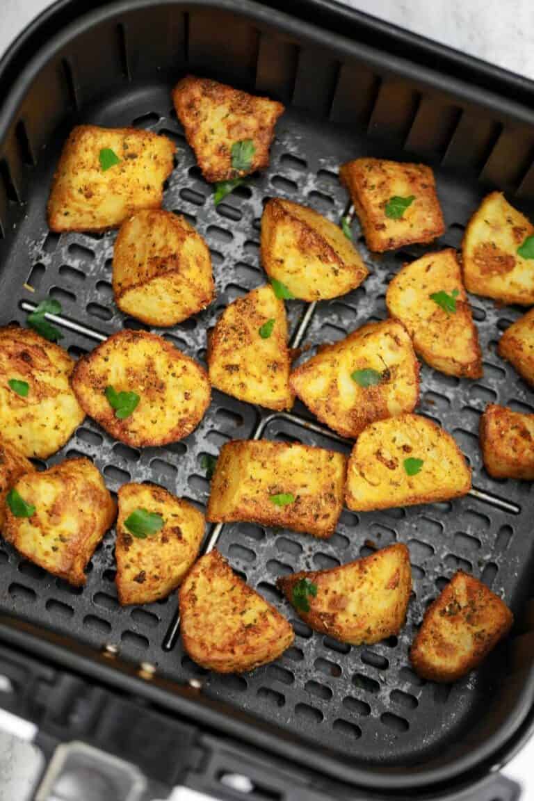 crispy potatoes in air fryer basket.