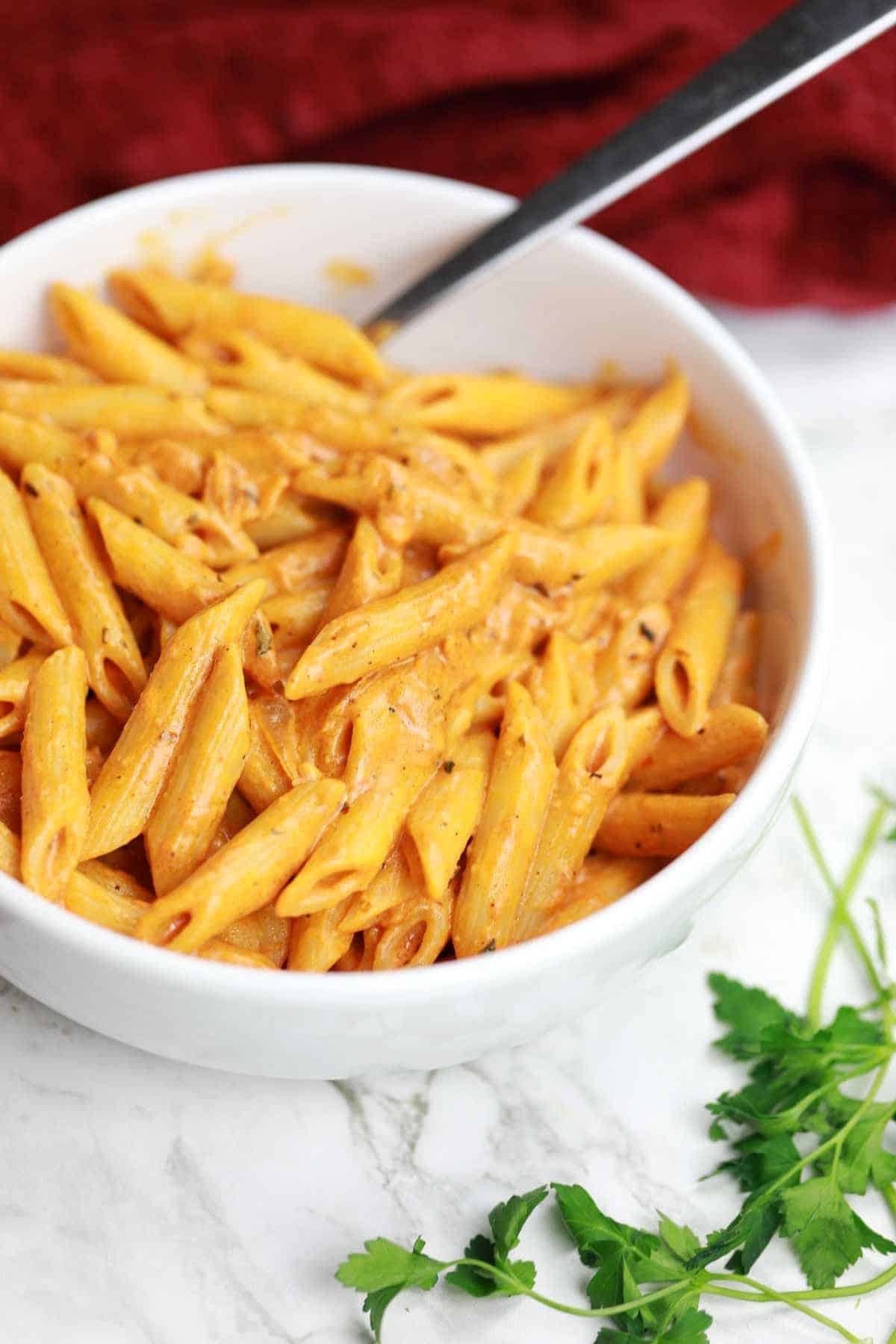 spicy pasta in a white plate.