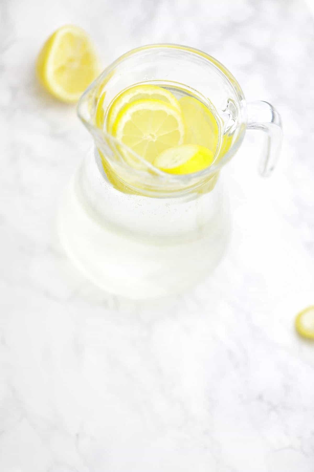 lemon infused water displayed in a pitcher.