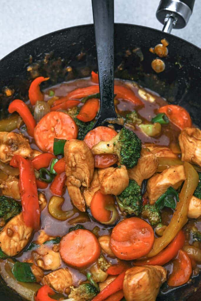 chinese chicken stir fry in a wok.