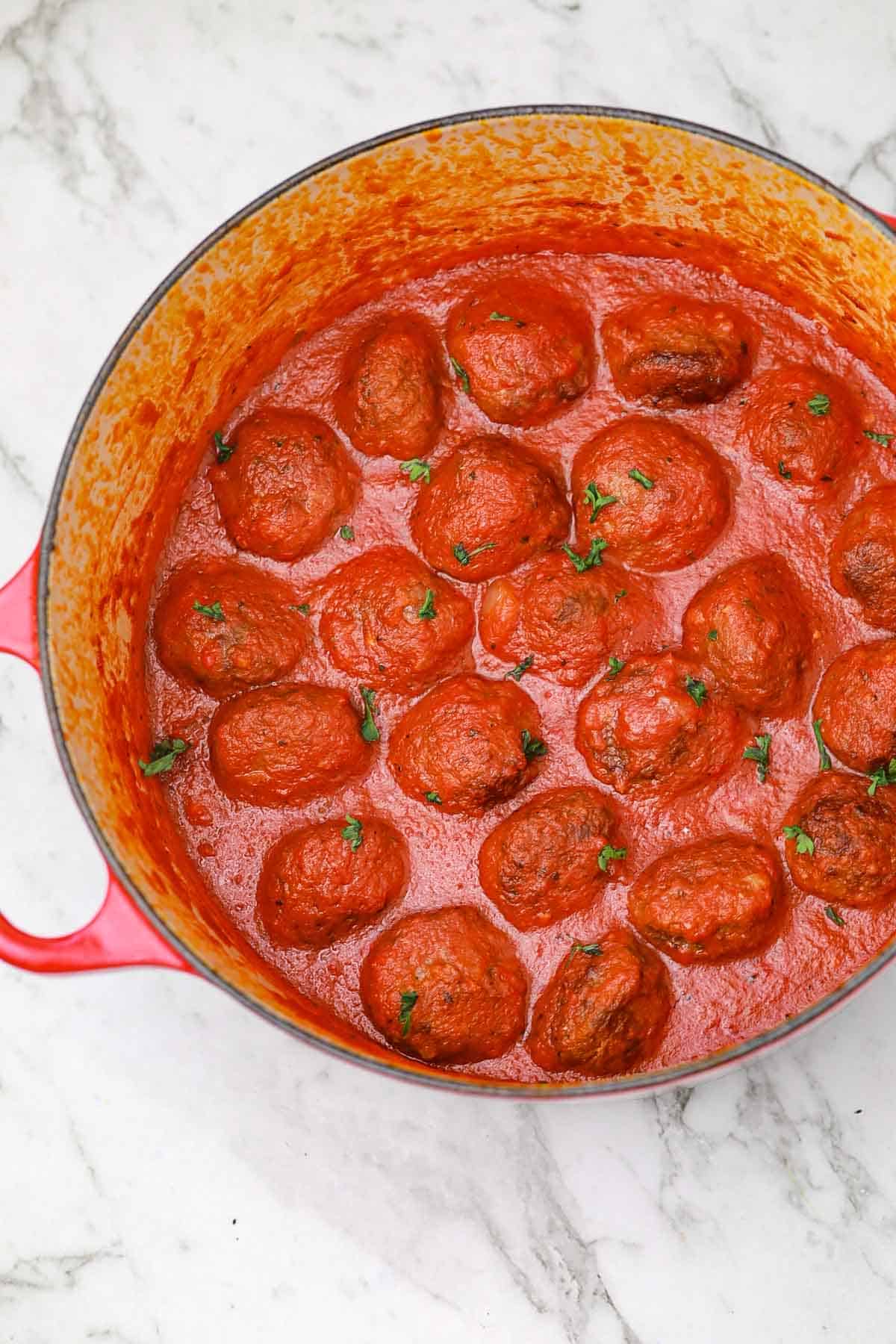 meatball sauce in a red pot.