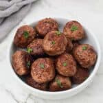 pan fried meatballs garnished with parsley.