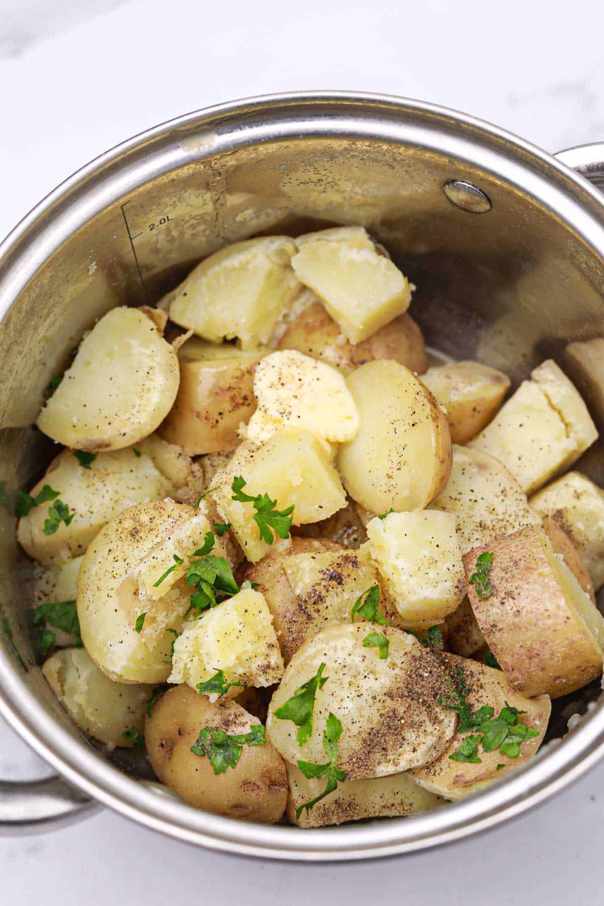 butter melting on the potatoes in the pot.