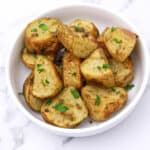 pesto potatoes garnished with parsley.