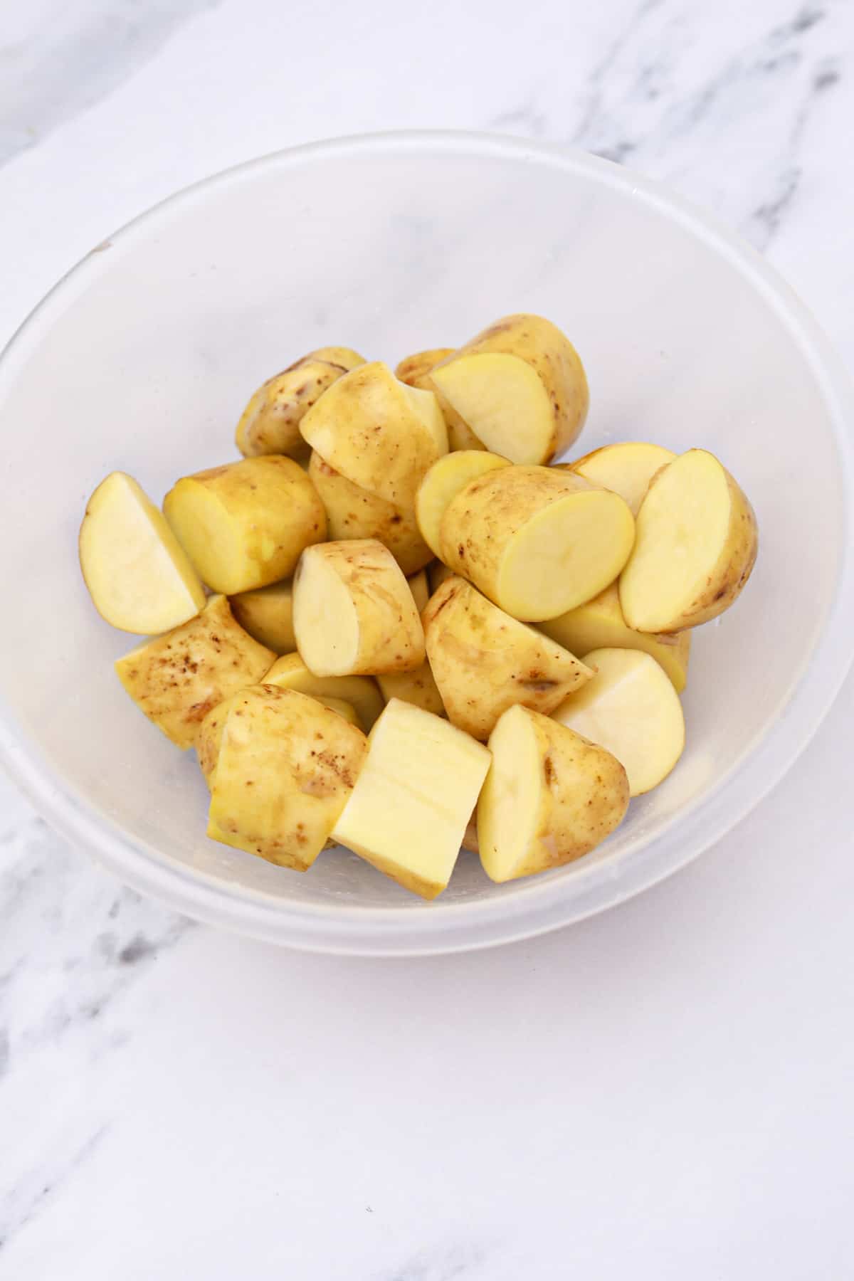 washed and cut potatoes in a bowl.