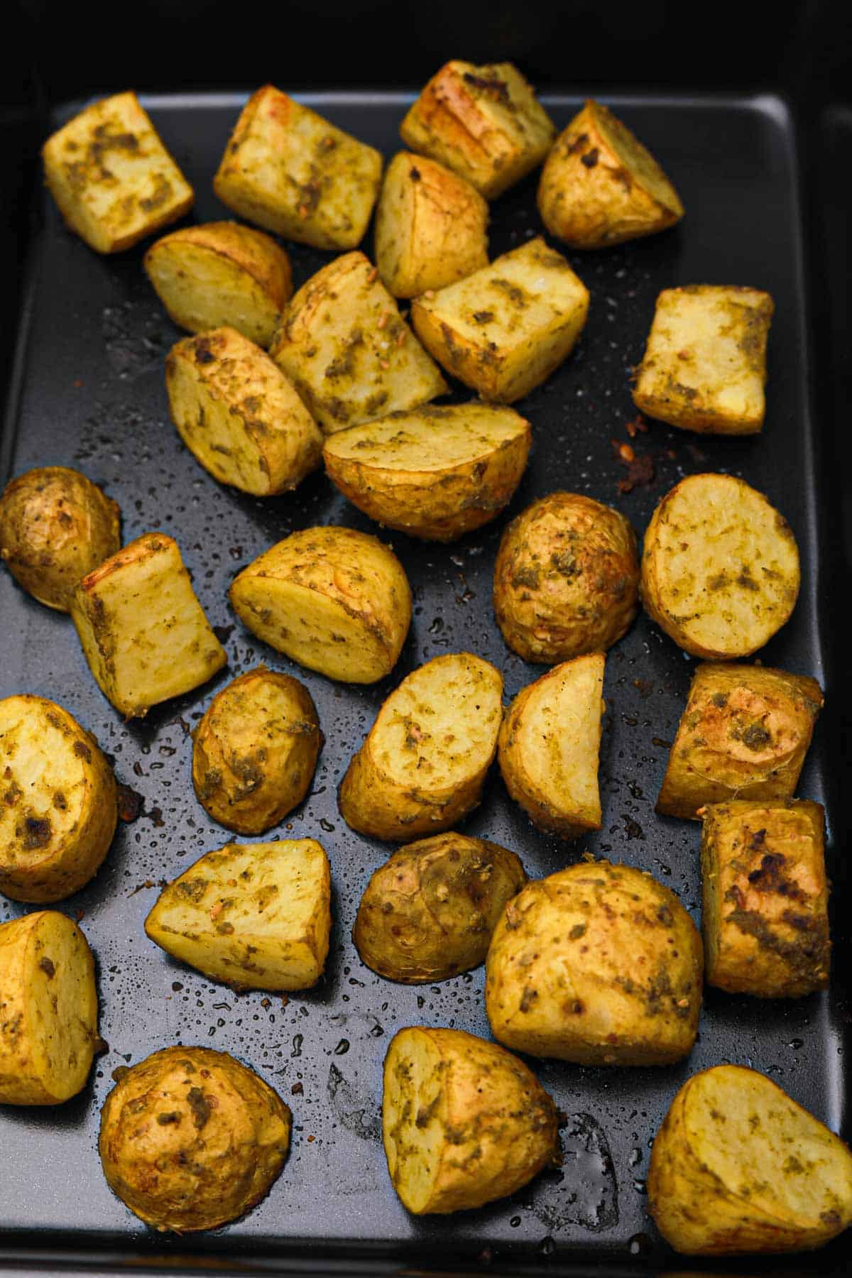roasted pesto potatoes in baking tray.