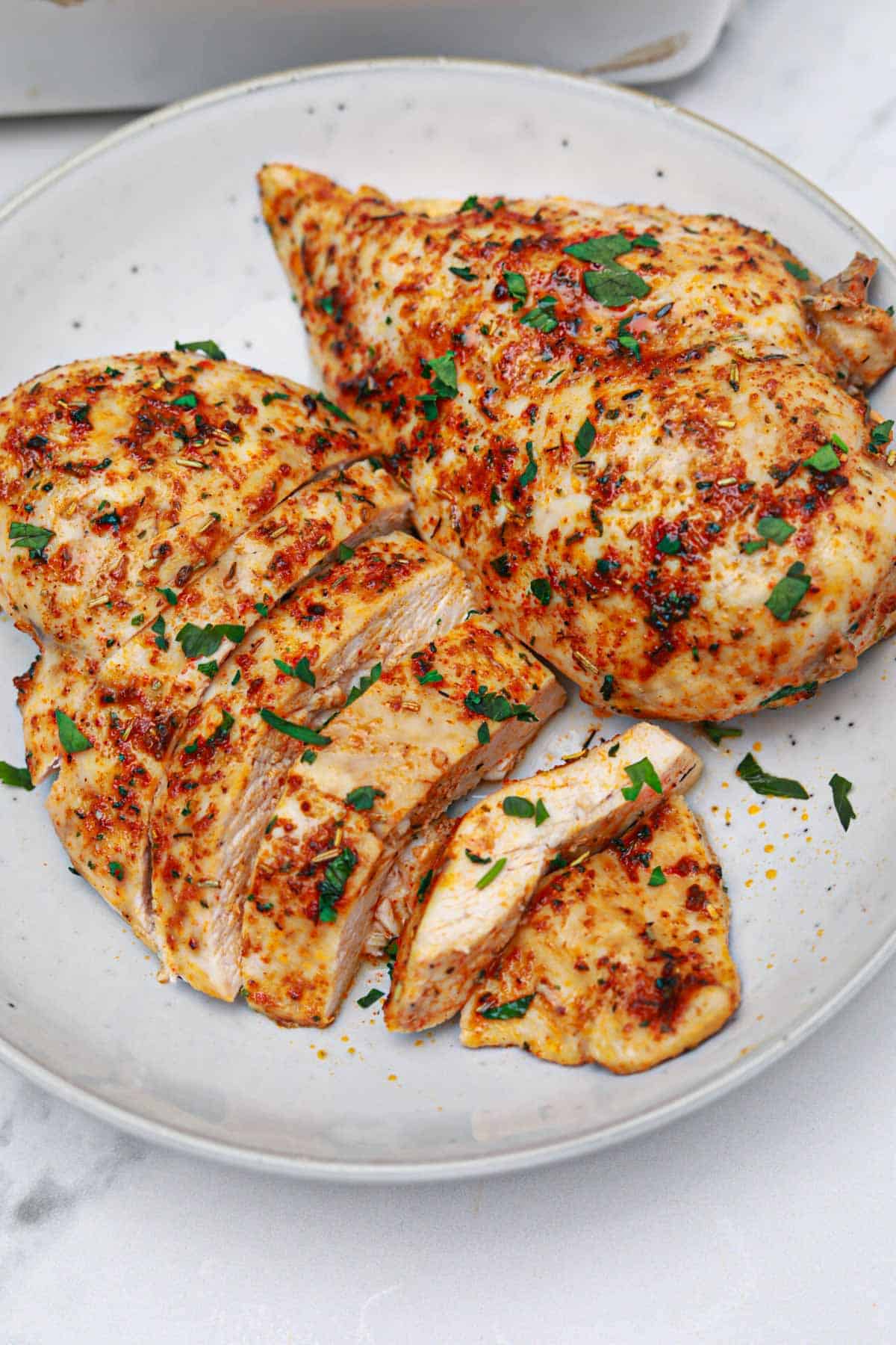 oven baked boneless chicken breasts served on a plate.