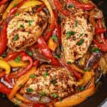 chicken with bell peppers and onions in a skillet.