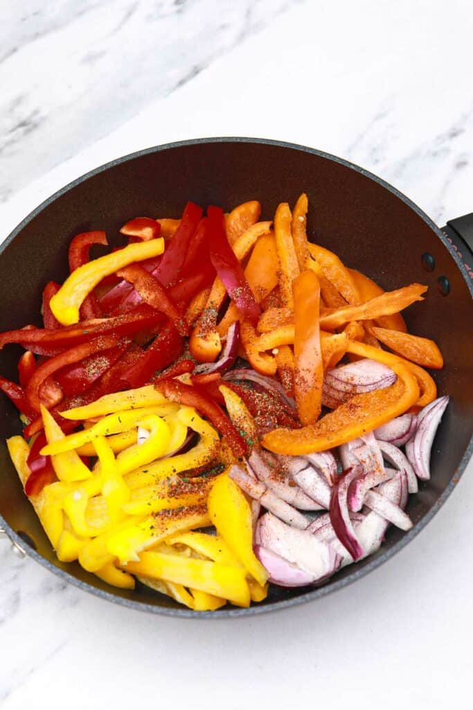 bell peppers, onions, and seasoning in a skillet.