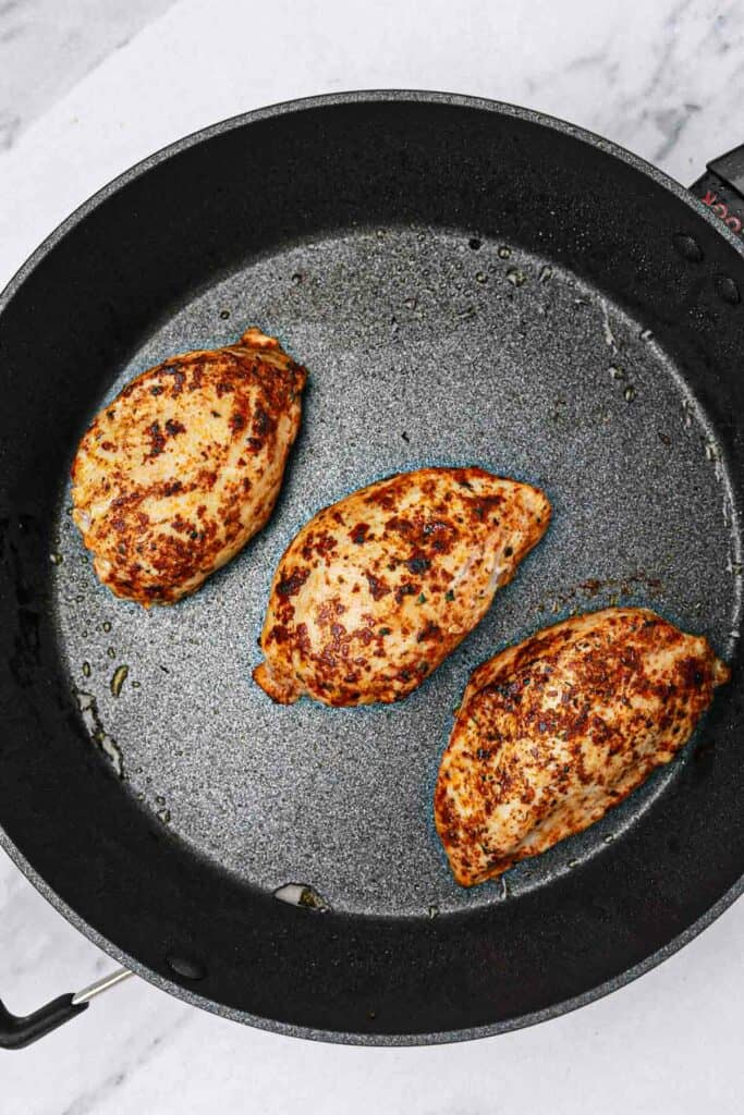 pan fried chicken in a skillet.