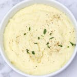 cream cheese mashed potatoes served in a white bowl.