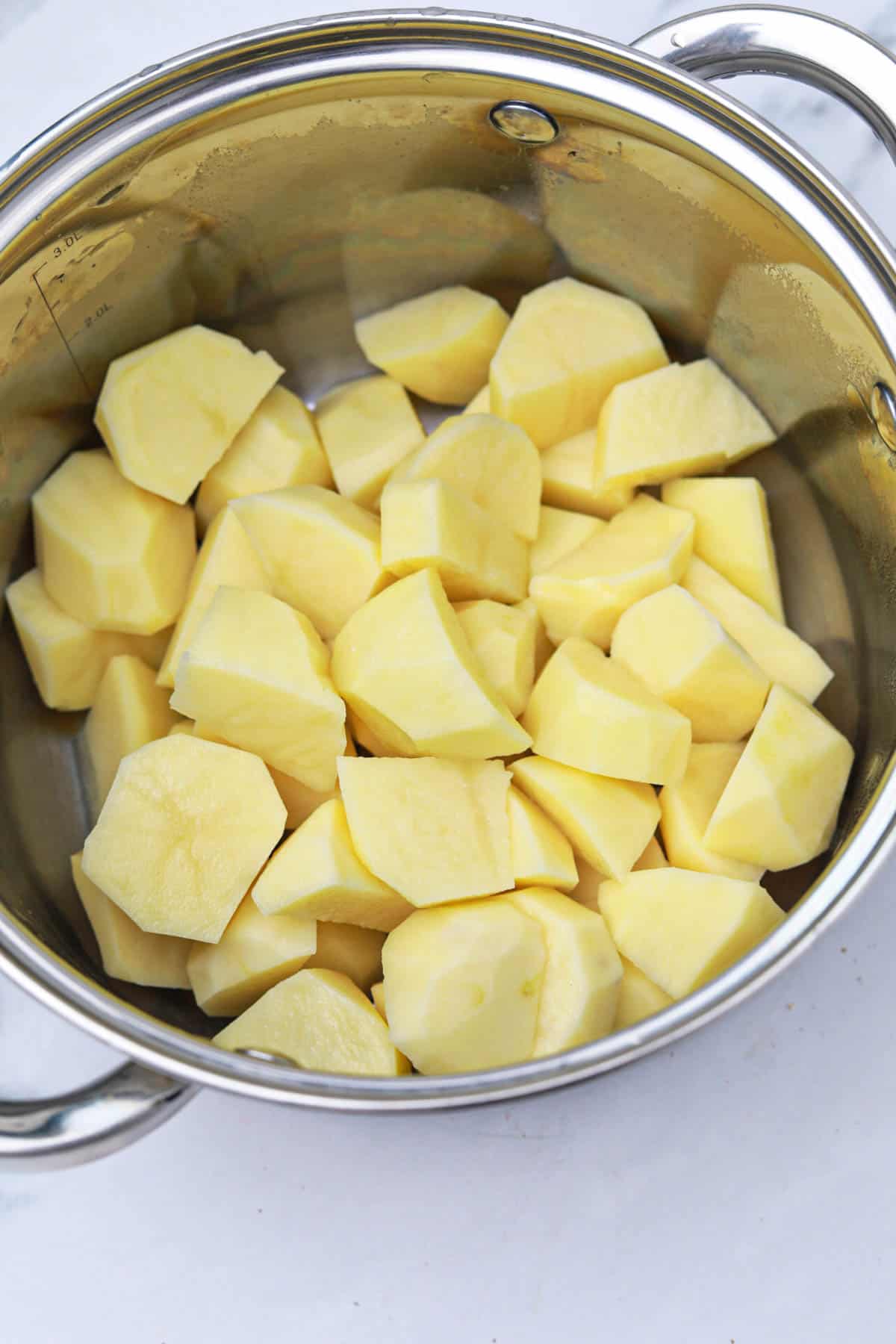 cut potatoes in a pot.