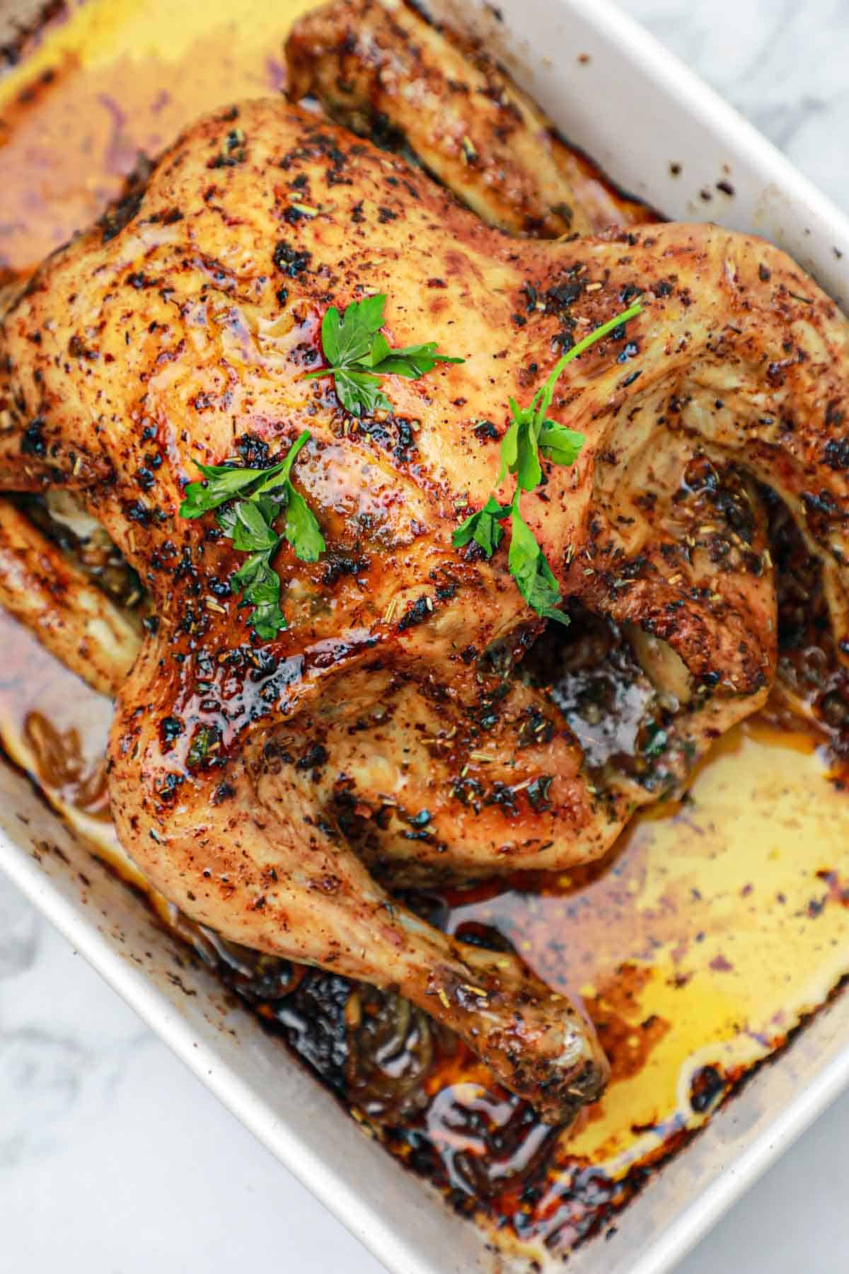 herb roasted chicken in a baking dish.