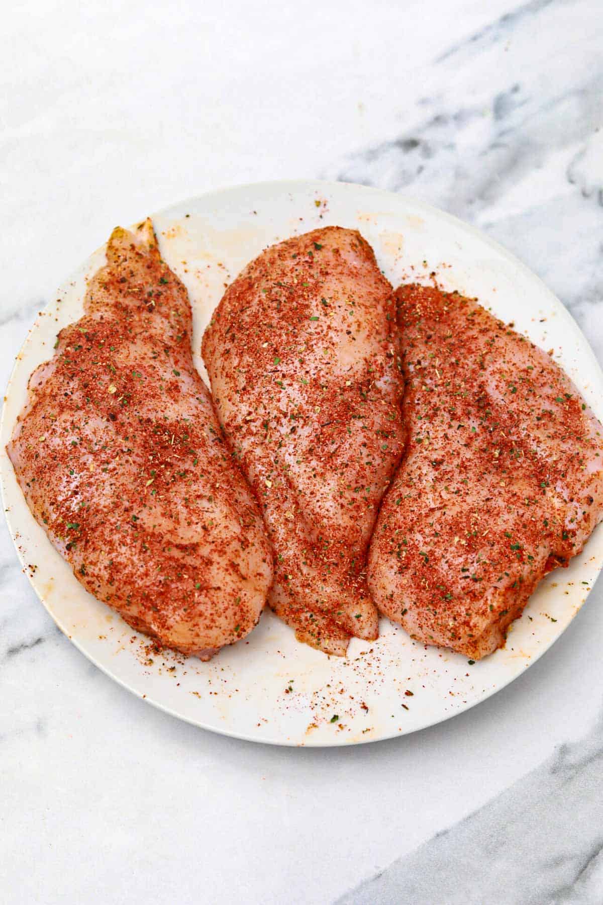 seasoned chicken on a white plate.