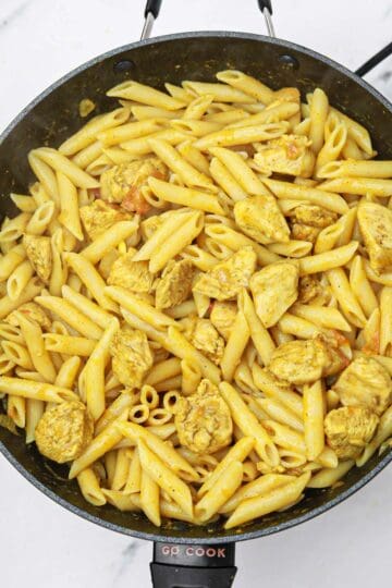Chicken curry pasta in a pan.