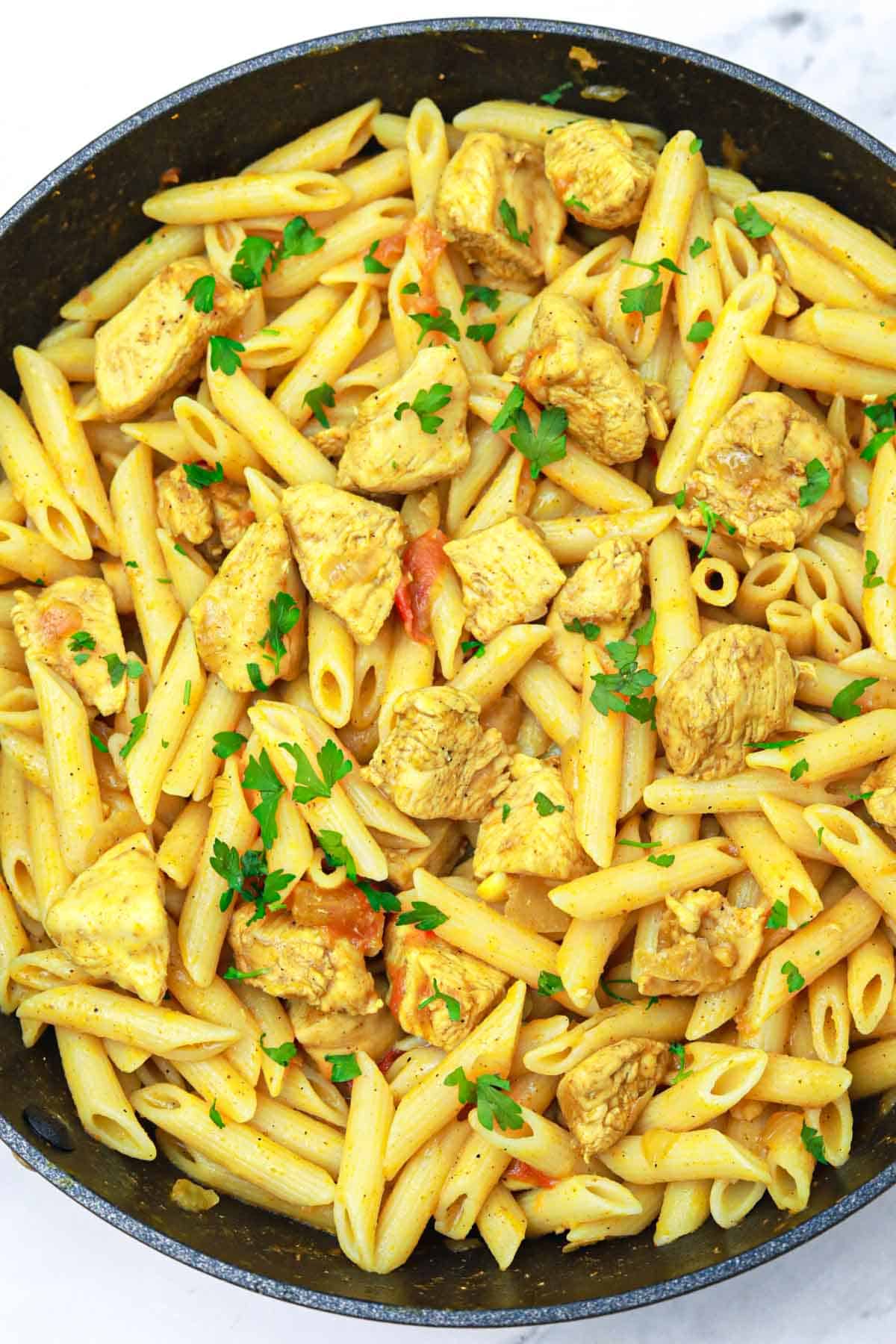 chicken curry pasta in a pan.