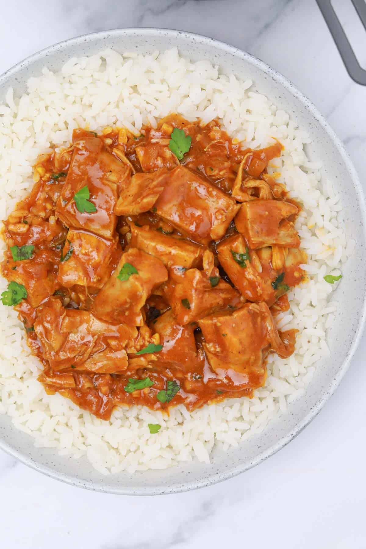 served on a white plate with rice.