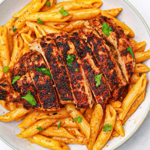 blackened chicken and pasta on a plate.