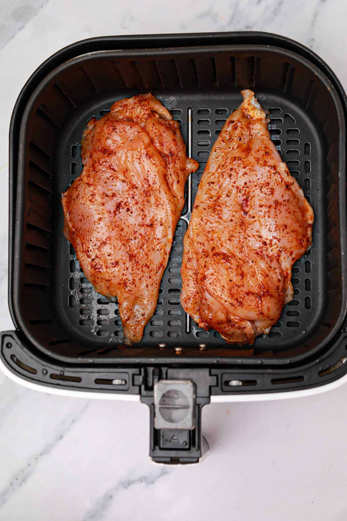 seasoned and arranged in the air fryer basket.