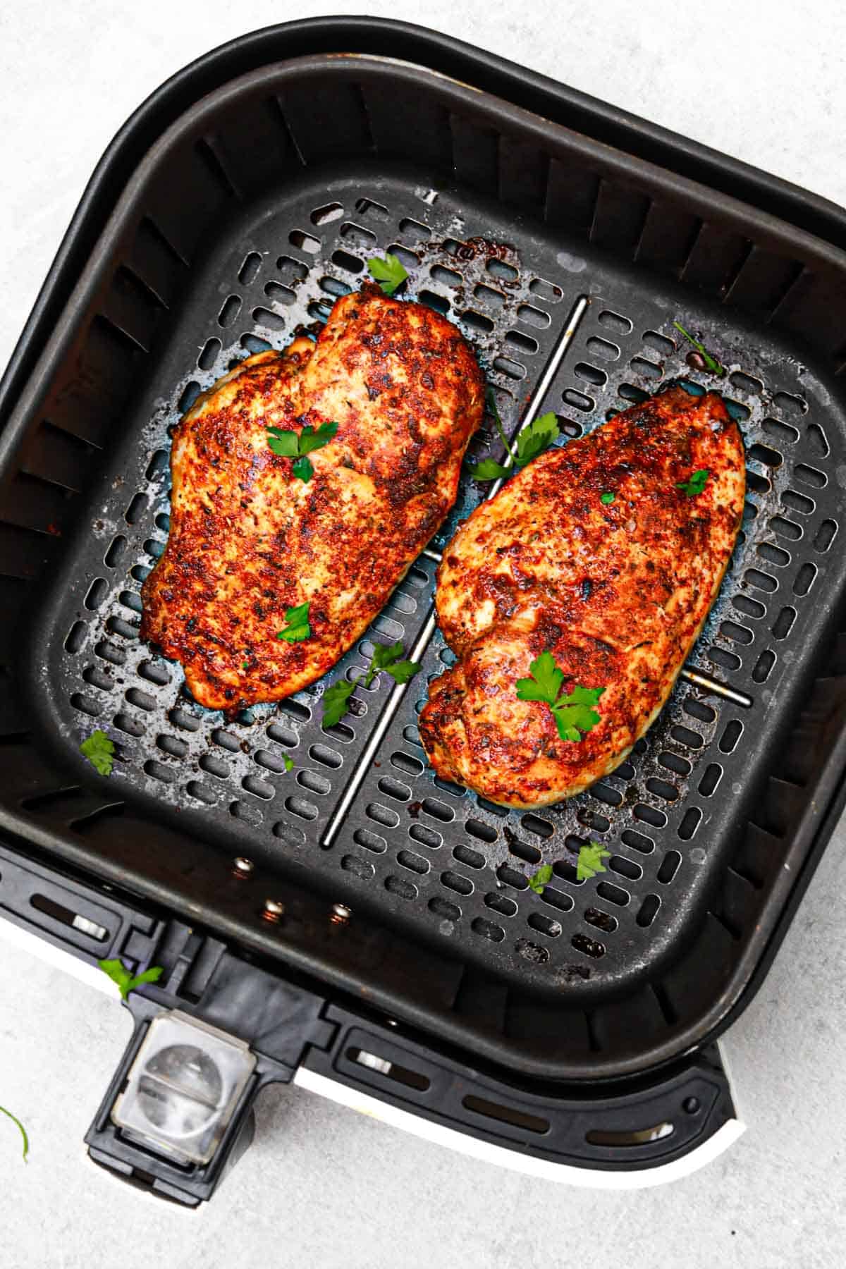 displayed in the air fryer and garnished with parsley.