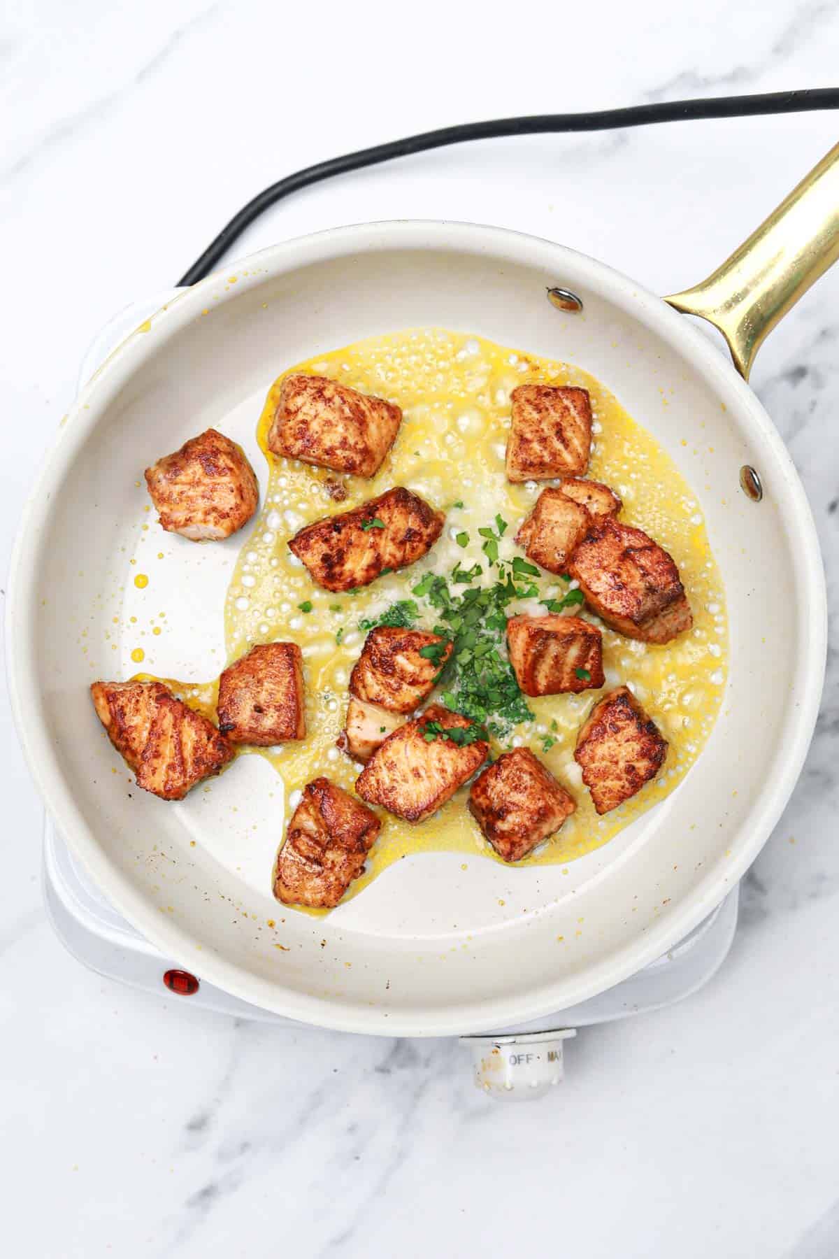 butter, garlic, and parsley added to the skillet.