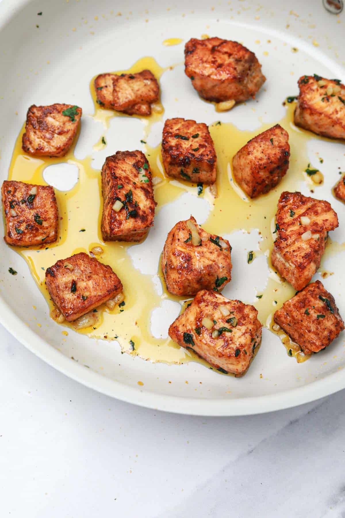 cooked salmon bites in the skillet.

