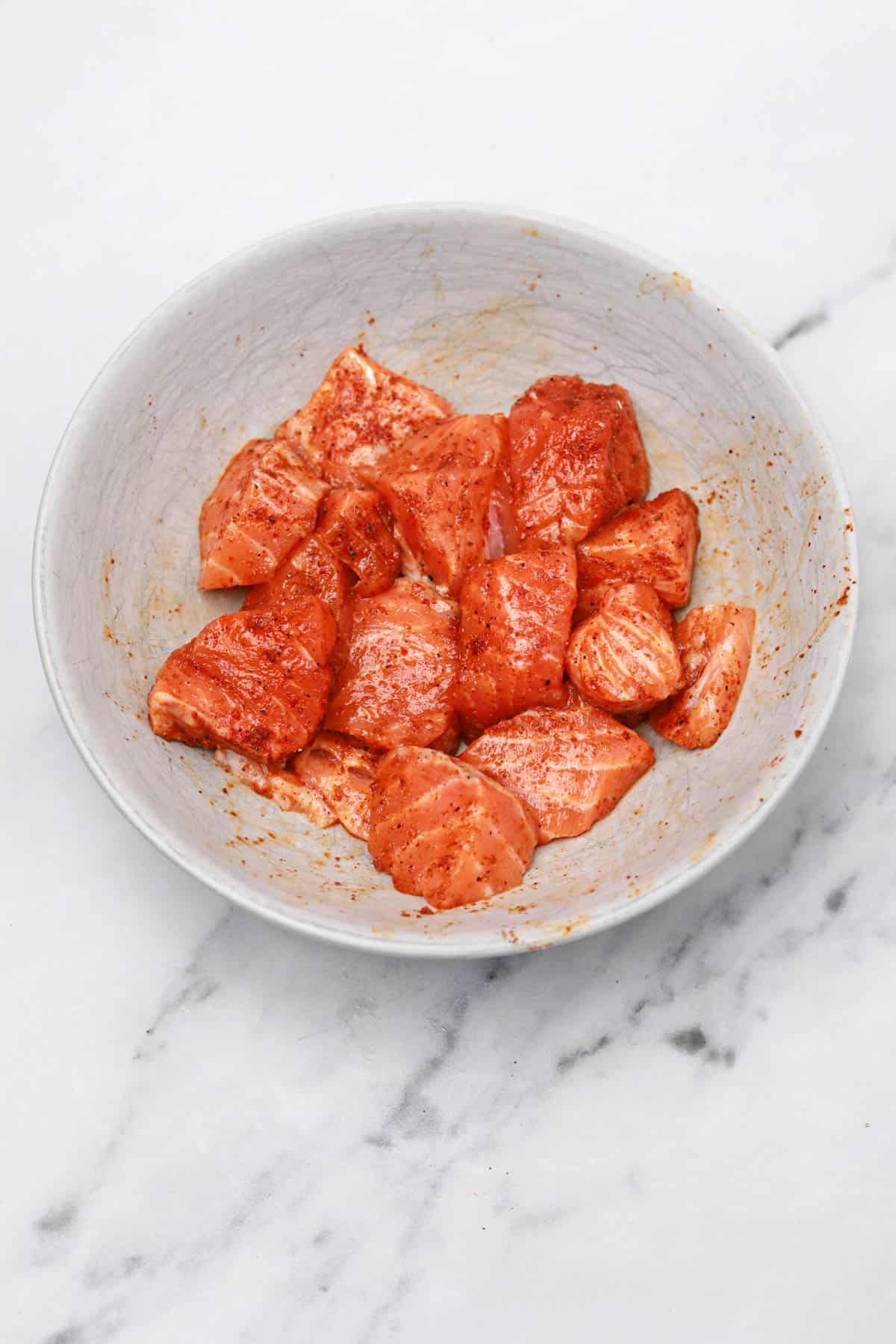 seasoned salmon bites in a bowl.