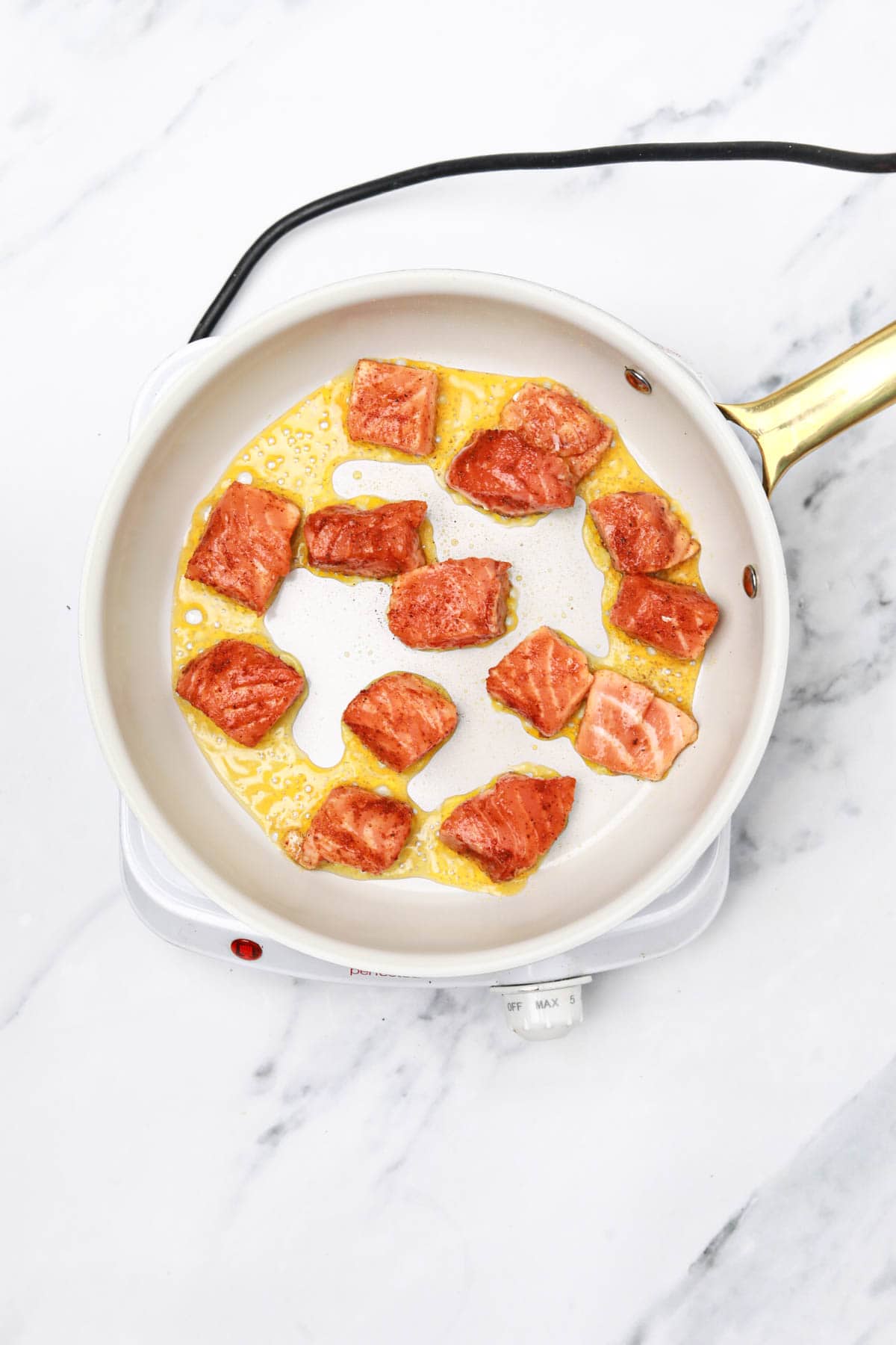 salmon bites in a skillet.