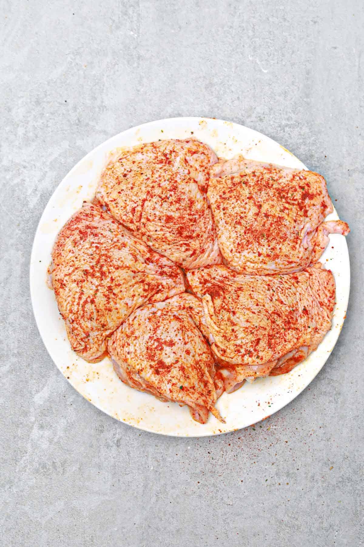 cleaned, and seasoned chicken thighs.