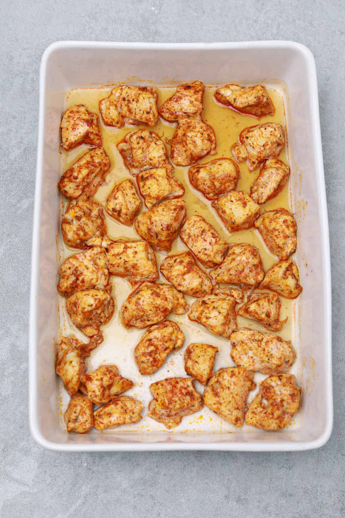 baked chicken bites in baking dish.