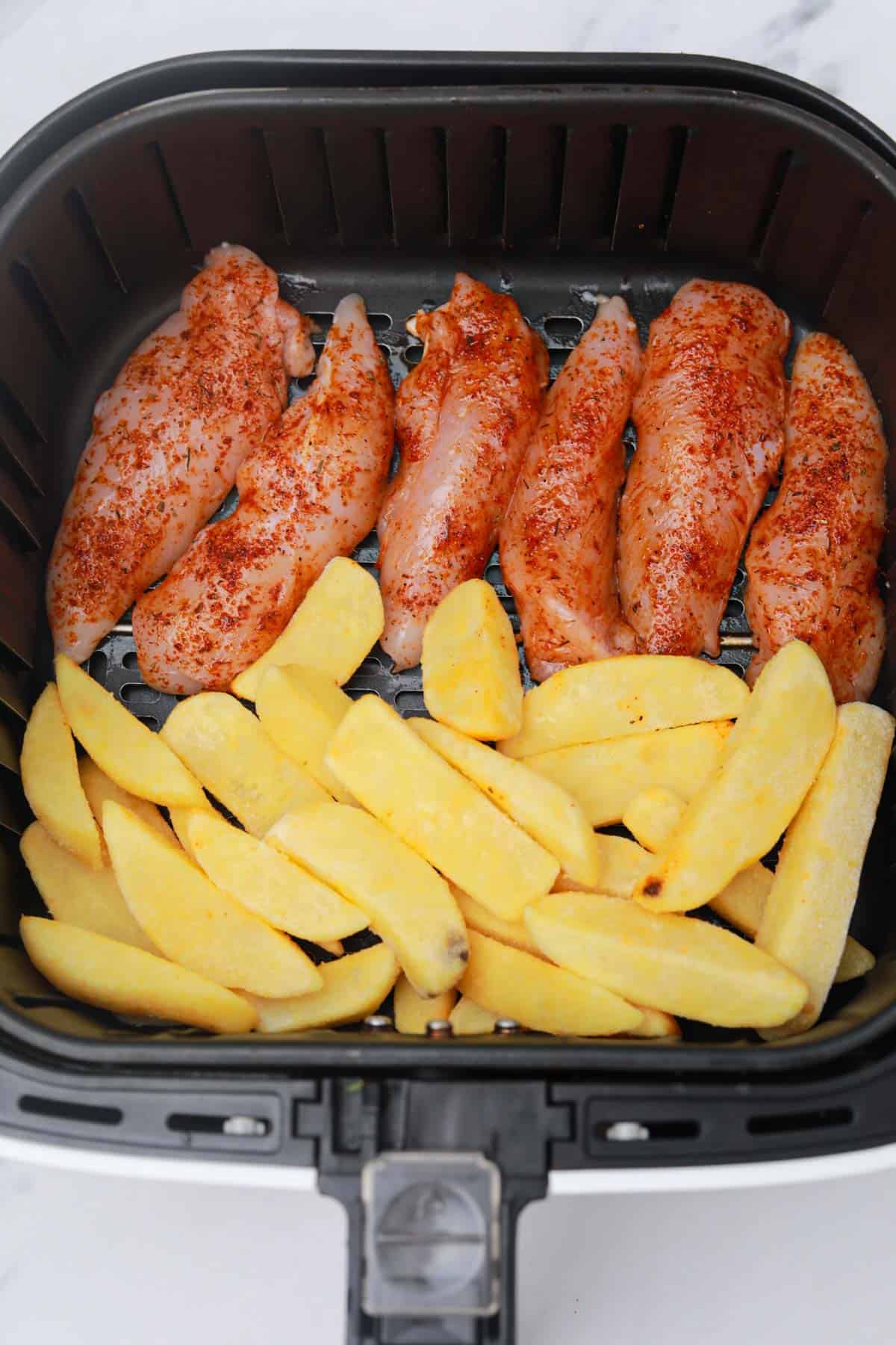 chicken tenders and fries in air fryer.