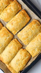 chicken hand pies on a baking tray.