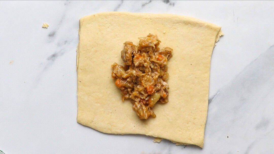 chicken filling in a cut pastry.