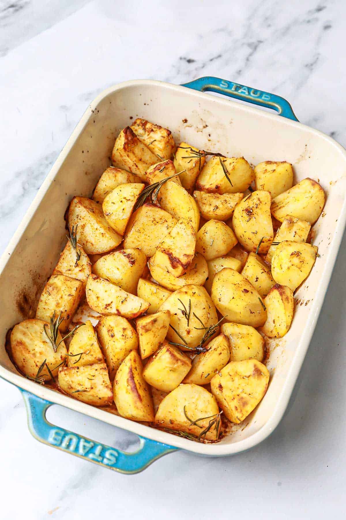 garlic rosemary roasted potatoes in a baking dish.