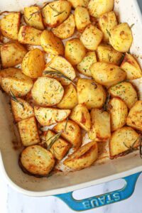 garlic rosemary roasted potatoes in a baking dish.