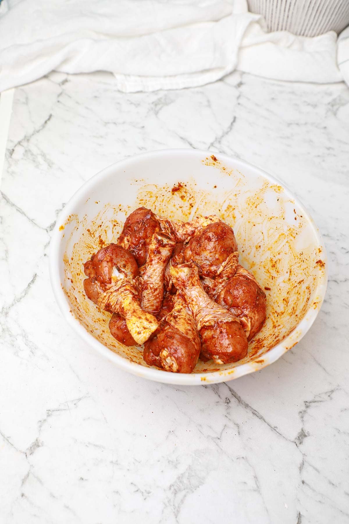 seasoned drumsticks in a bowl.