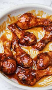 honey barbecue drumsticks in a pan.
