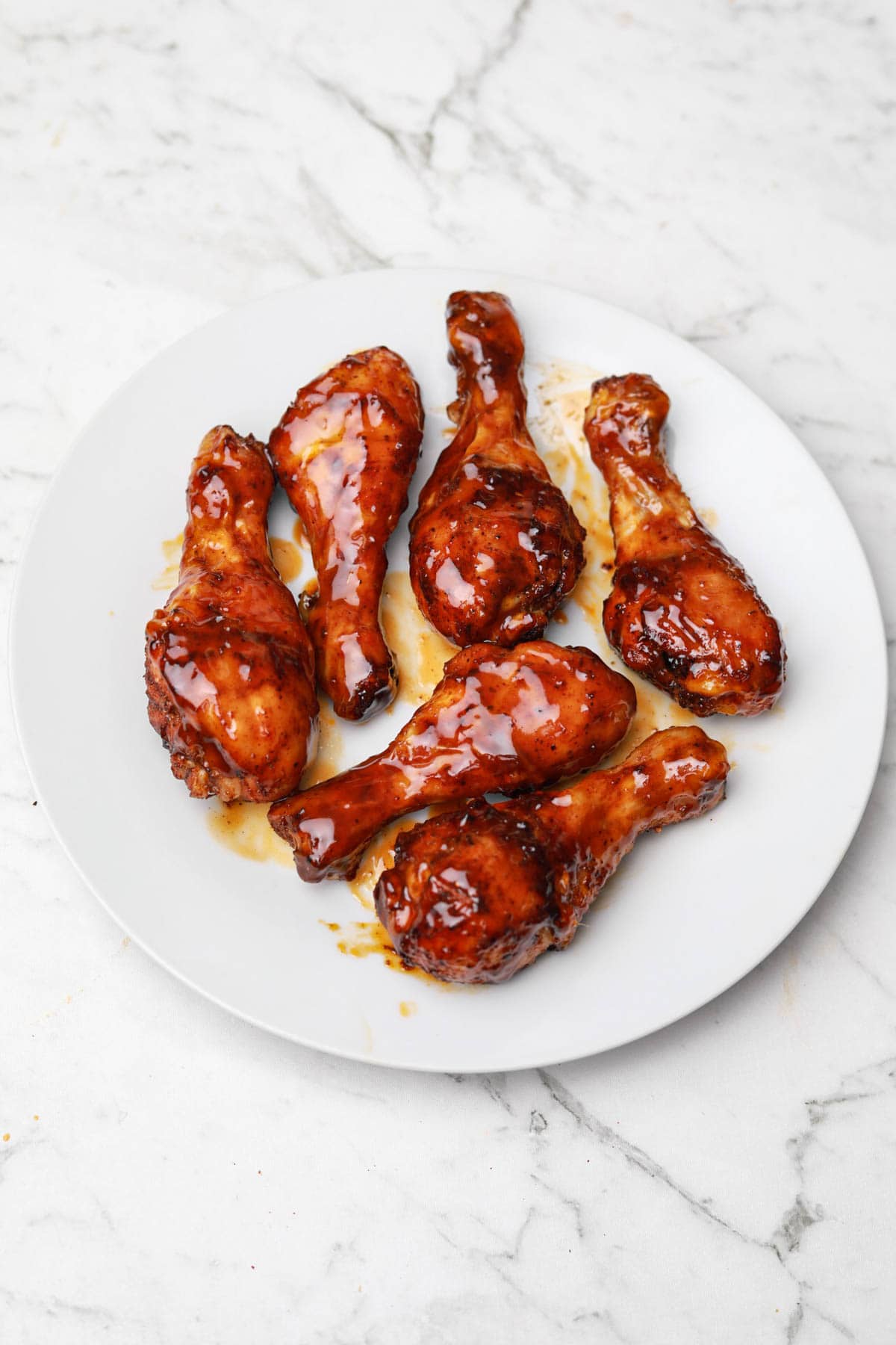 honey bbq chicken drumsticks on a plate.