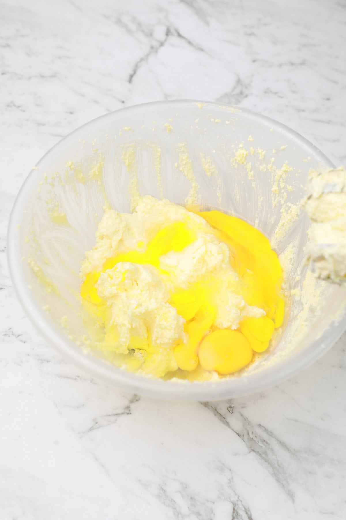 eggs and vanilla extract added to the bowl.