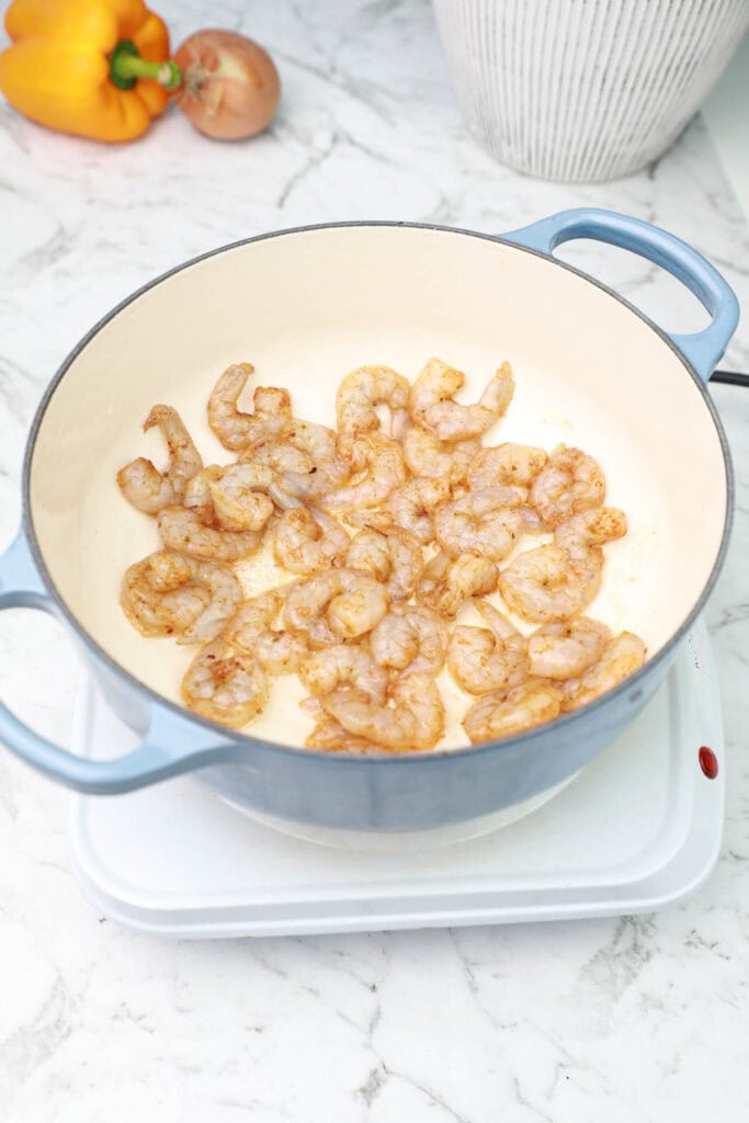 pan frying shrimp in a pot.