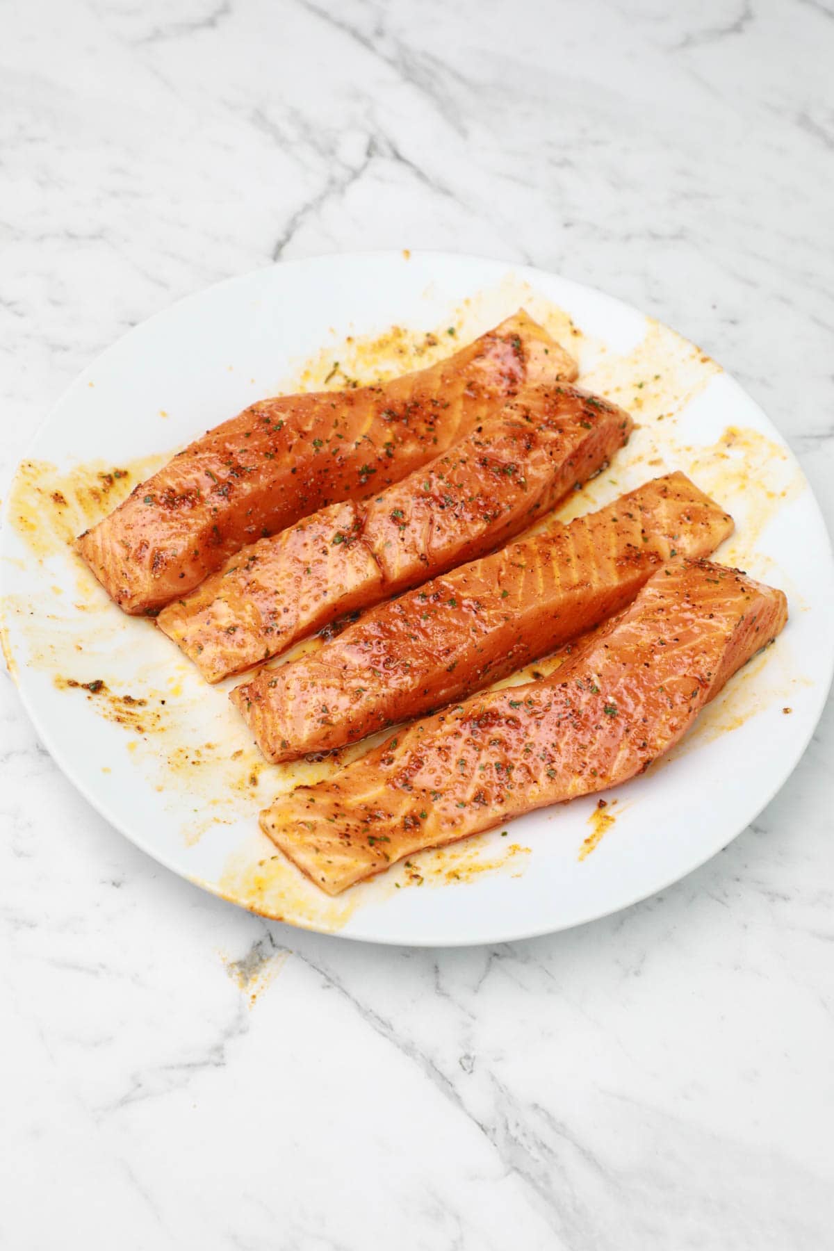 marinated fillets on a white plate.