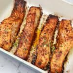 broiled salmon fillets in a baking dish.