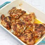 baked frozen chicken thighs in a baking dish.